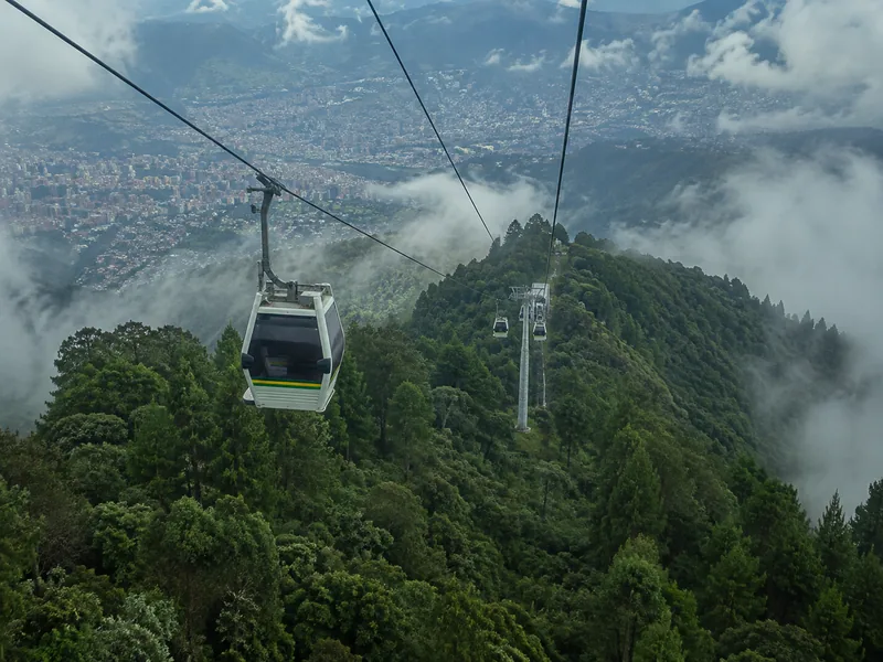 Metrocable gondola crossing cloud forest toward Parque Arví above Medellín